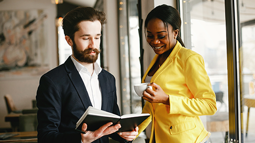 Two corporate people standing talking